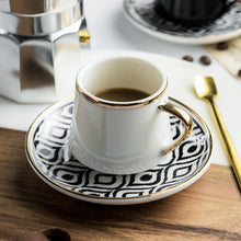 Lade das Bild in den Galerie-Viewer, Kaffeetasse mit Unterteller in schwarz-weißen Muster und goldenen Akzenten inkl. goldenem Löffel
